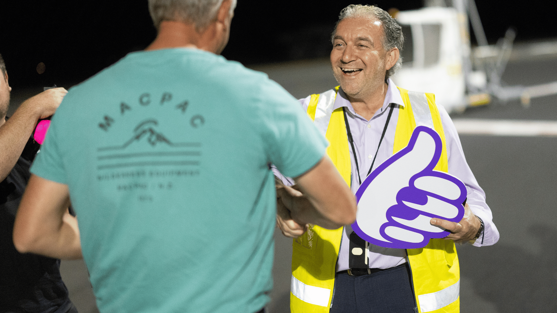 Coffs Harbour Airport General Manager Frank Mondello shaking hands with passenger.